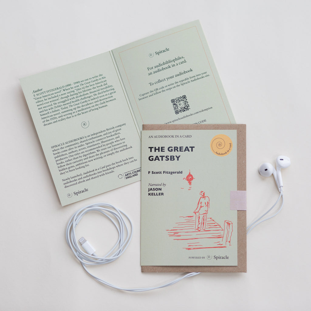 Card with 'The Great Gatsby' cover and earphones on a white background