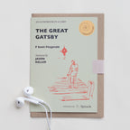 Card with 'The Great Gatsby' audiobook cover and earphones on a white background