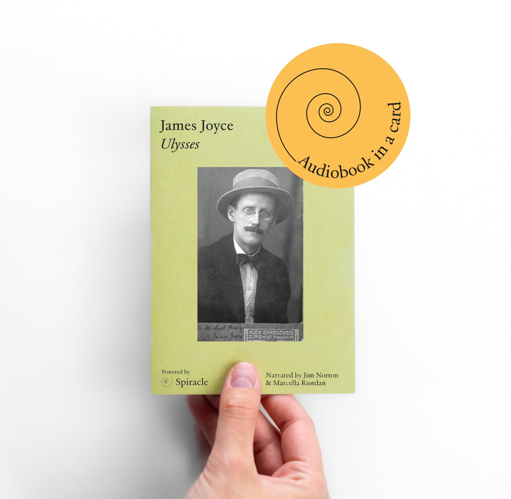 Hand holding a book titled 'Ulysses' by James Joyce with an audiobook in a card label.